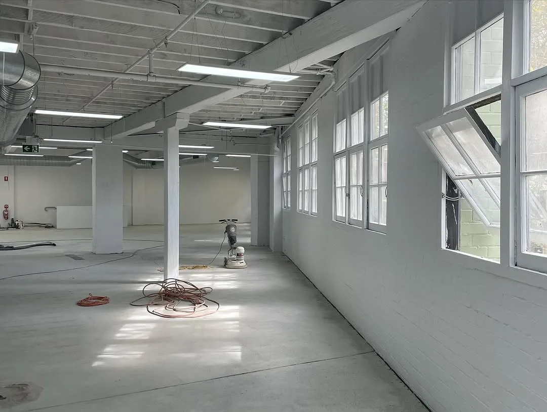 Commercial repaint, warehouse interior in white with exposed services, Sydney