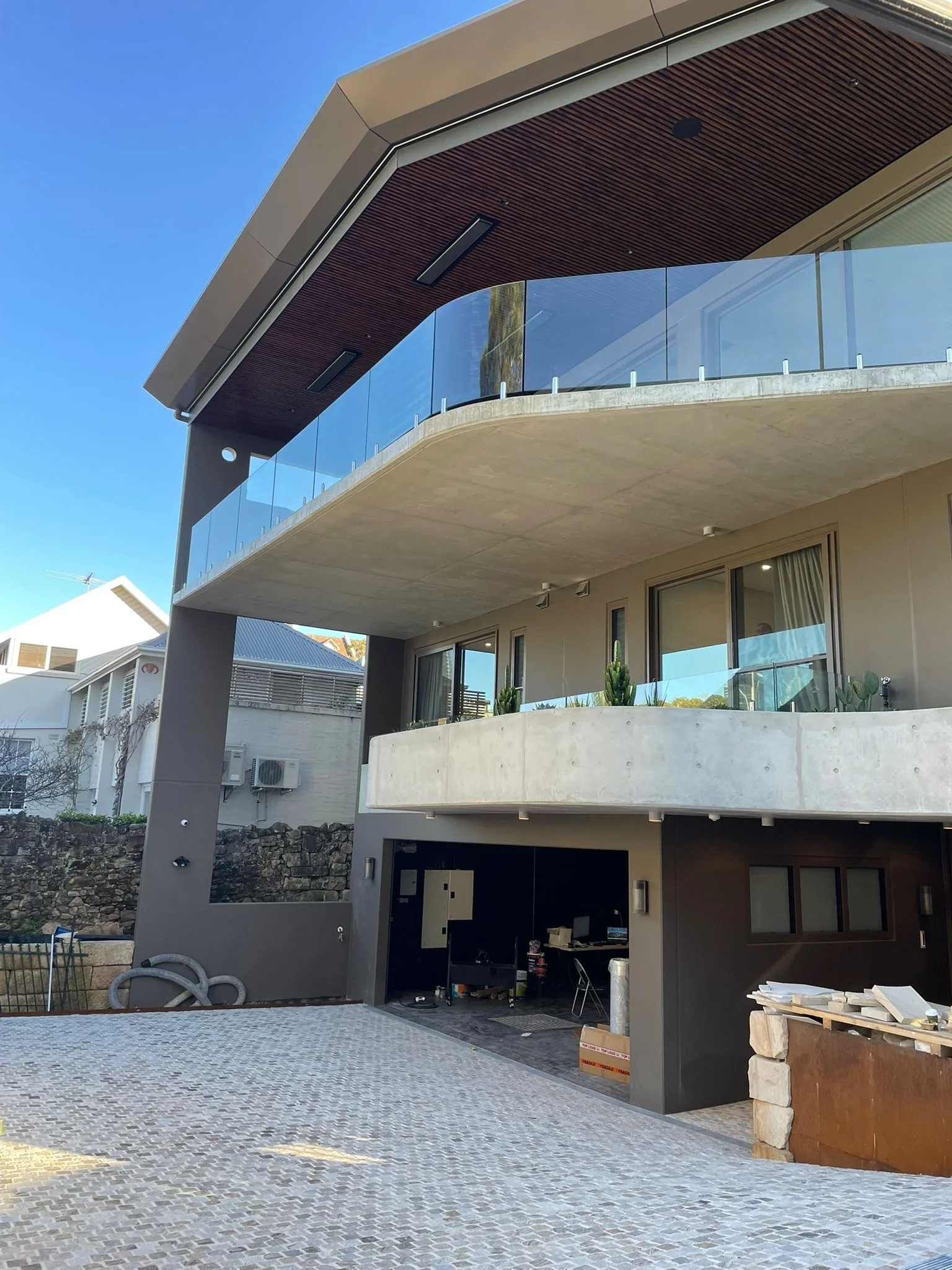 Exterior repaint, modern home with bronze soffit and glass balcony, Sydney