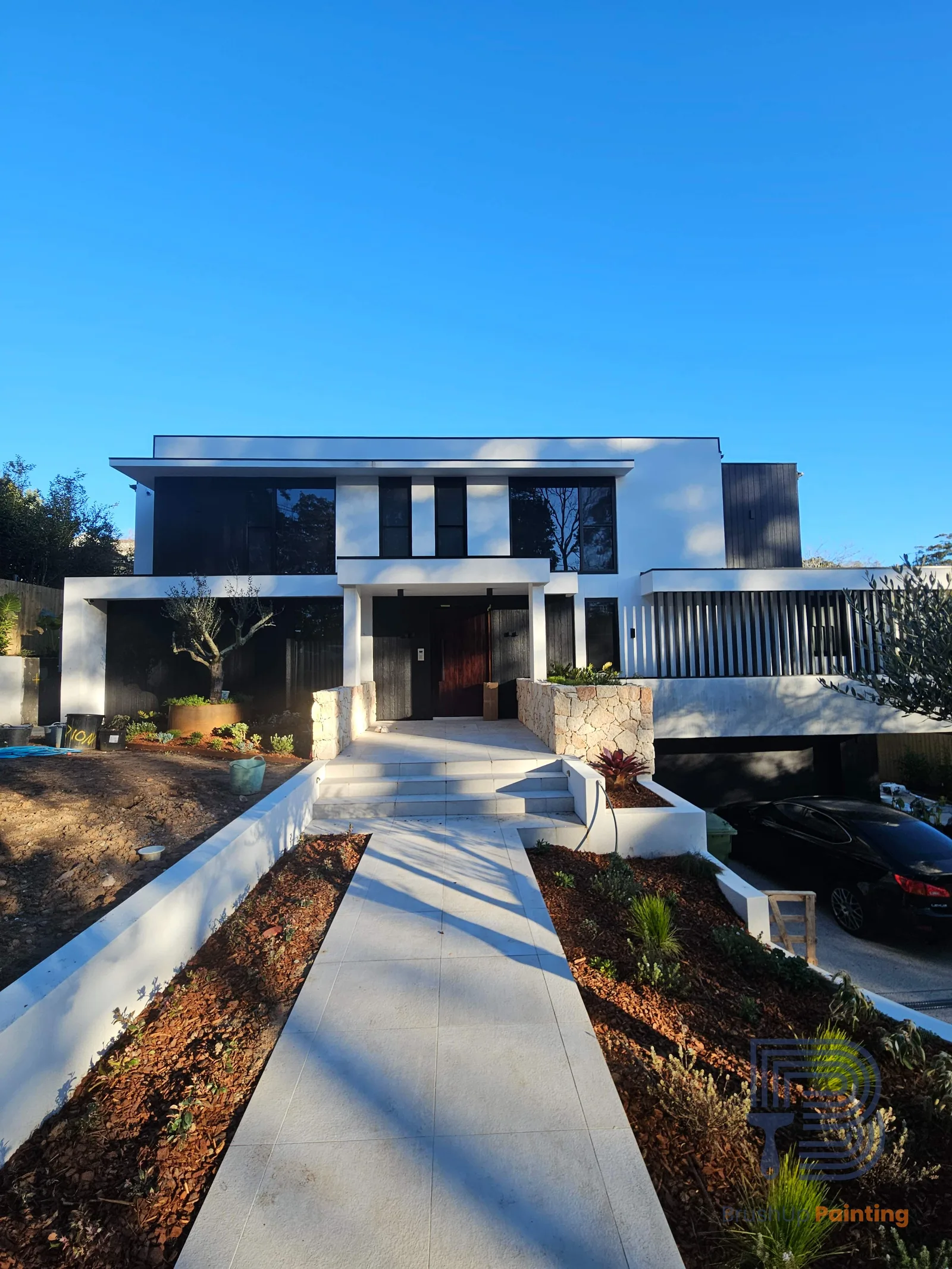 Exterior repaint, white render and black cladding on a two storey home, Sydney