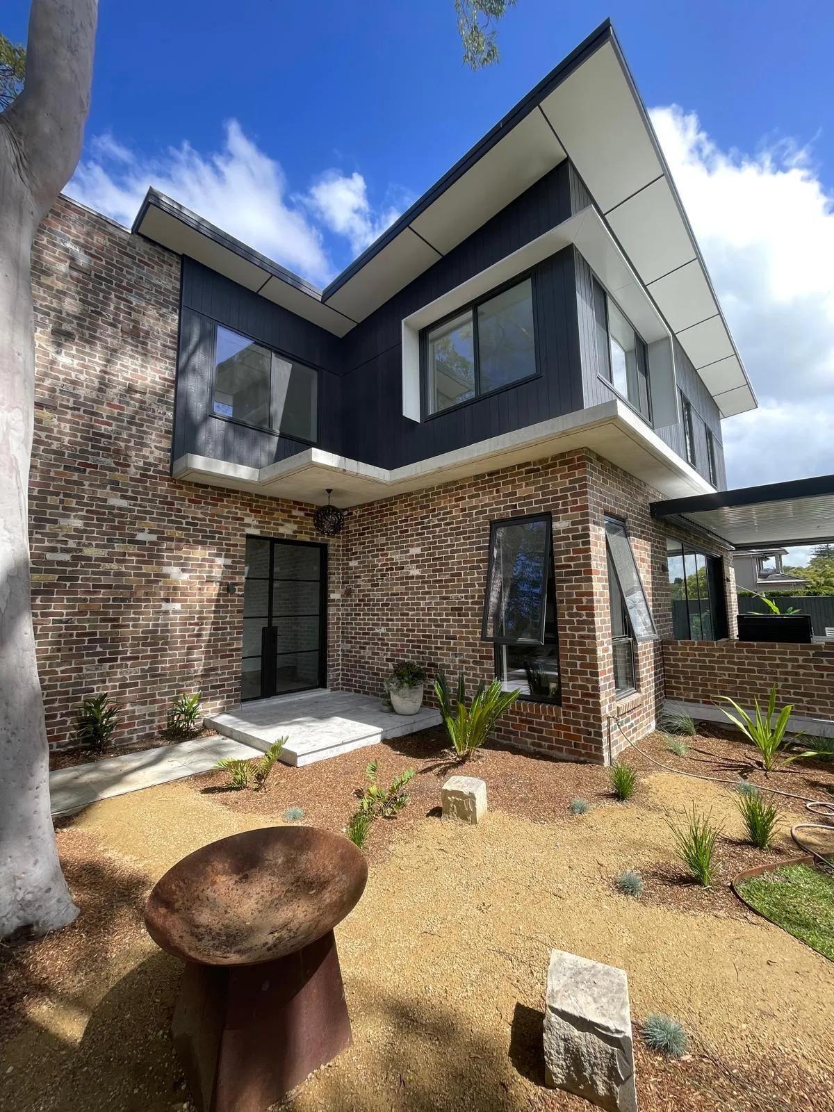 Exterior repaint, recycled brick and black cladding, Sydney