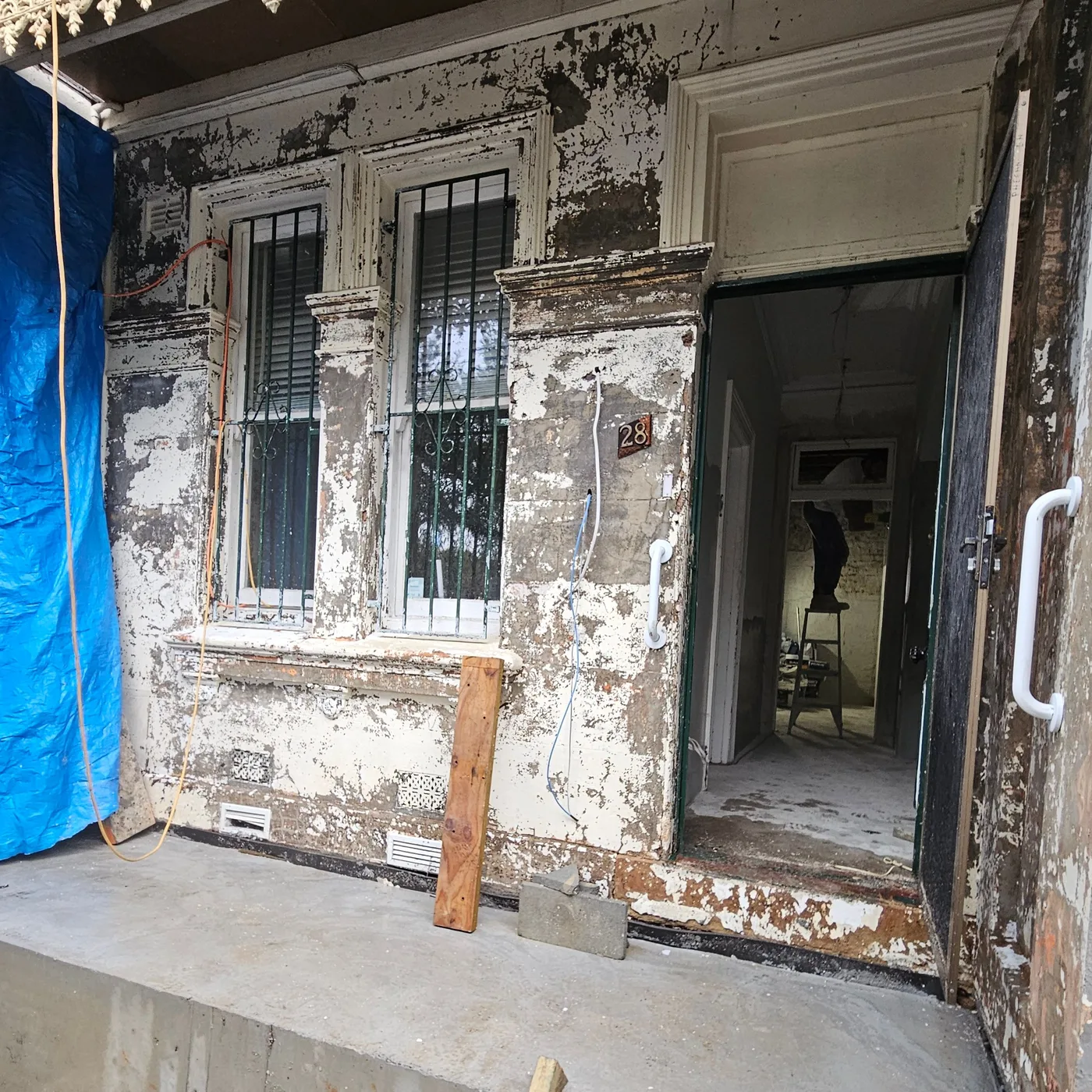 Heritage terrace porch stripped back to bare render before repainting, Sydney