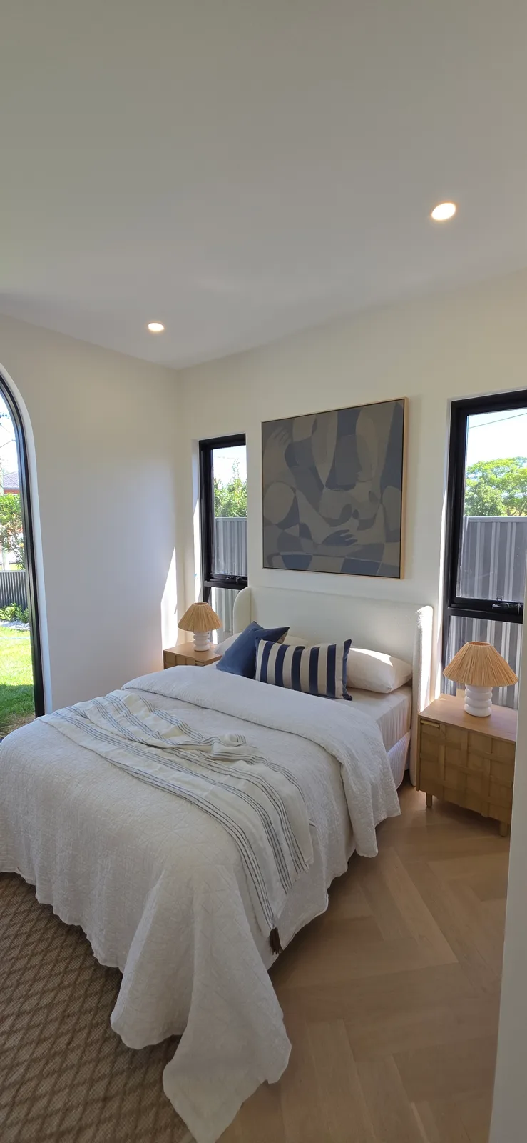 Interior repaint, guest bedroom with arched window and blue artwork, Sydney