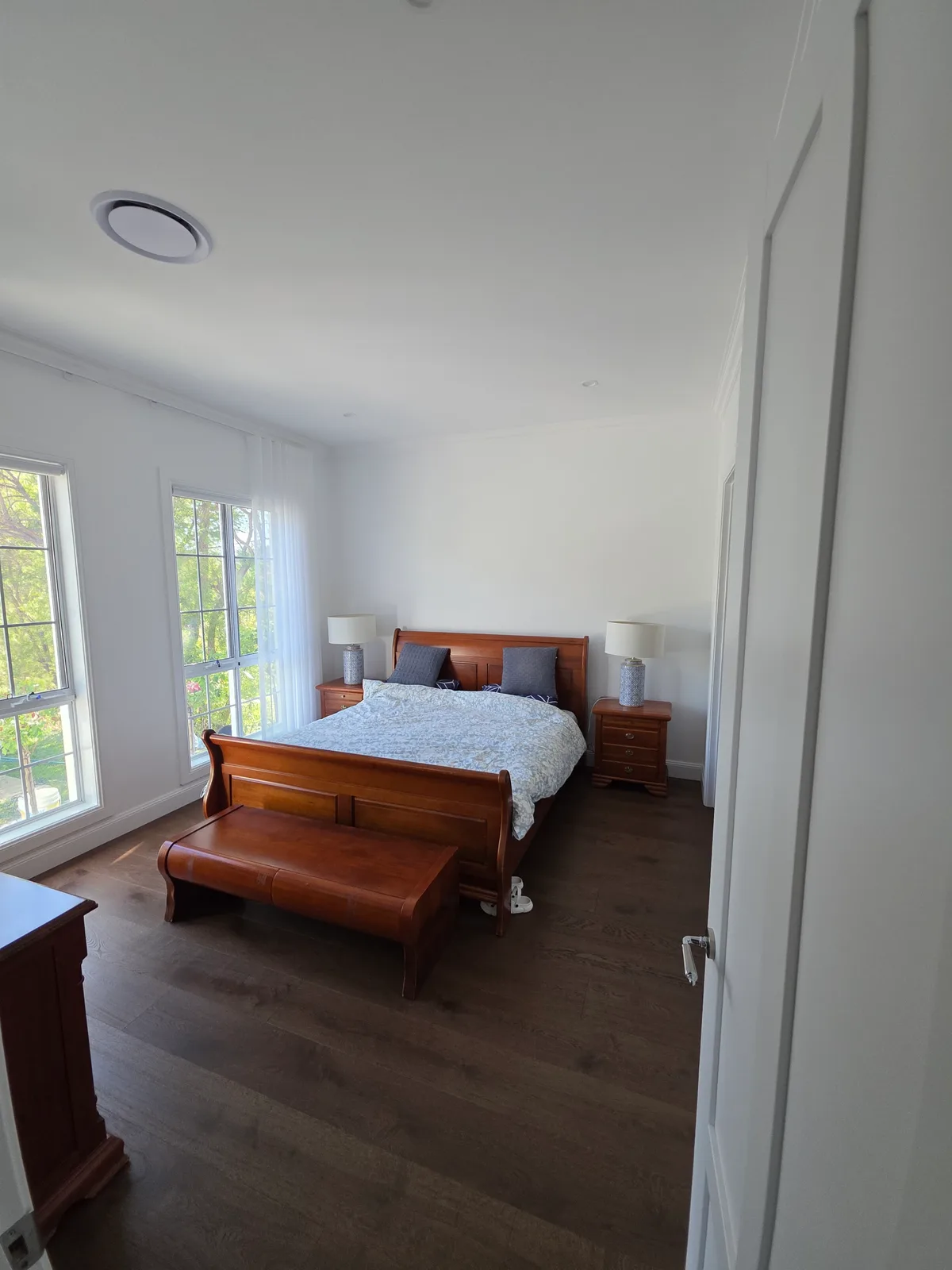 Interior repaint, bedroom with timber sleigh bed and sheer curtains, Sydney