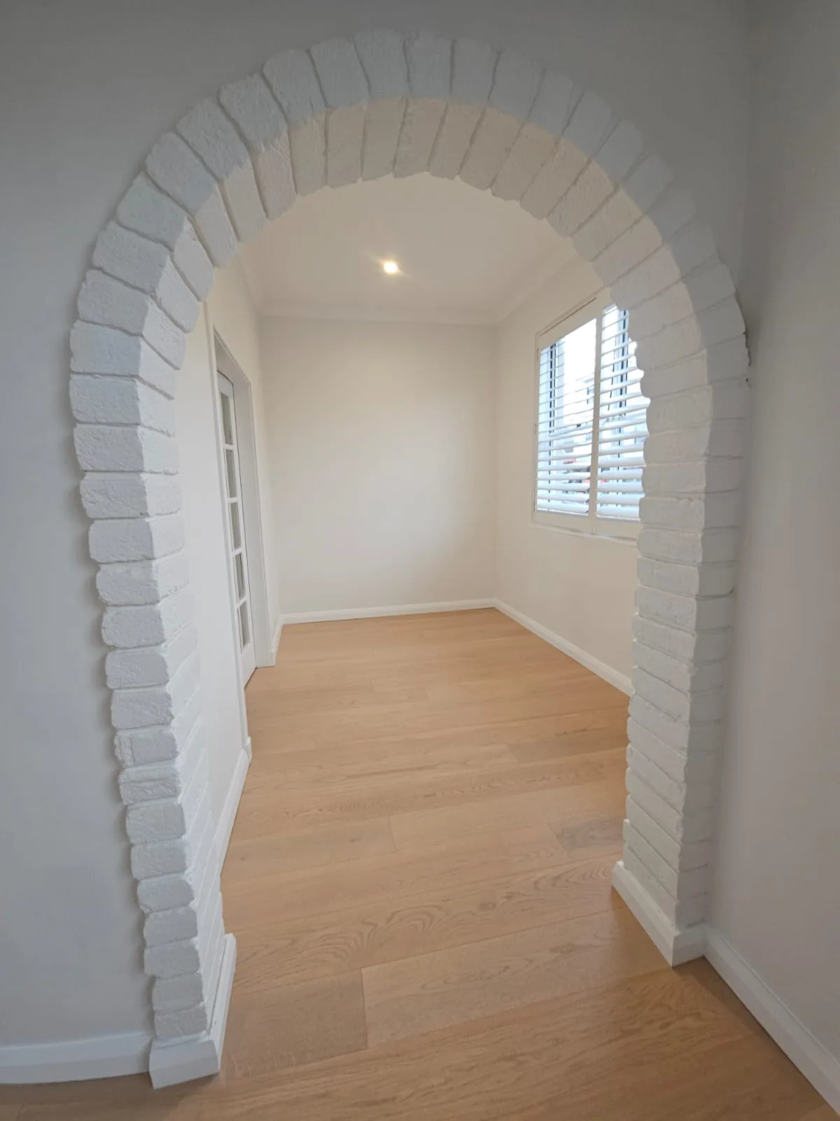 Interior repaint, painted brick archway in white, Sydney