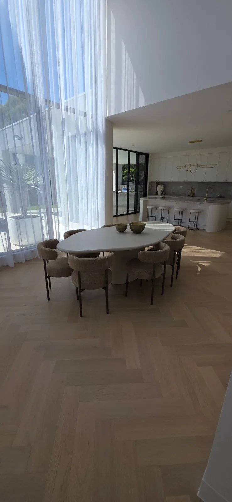 Interior repaint, open plan dining room with sheer curtains beside the kitchen, Sydney
