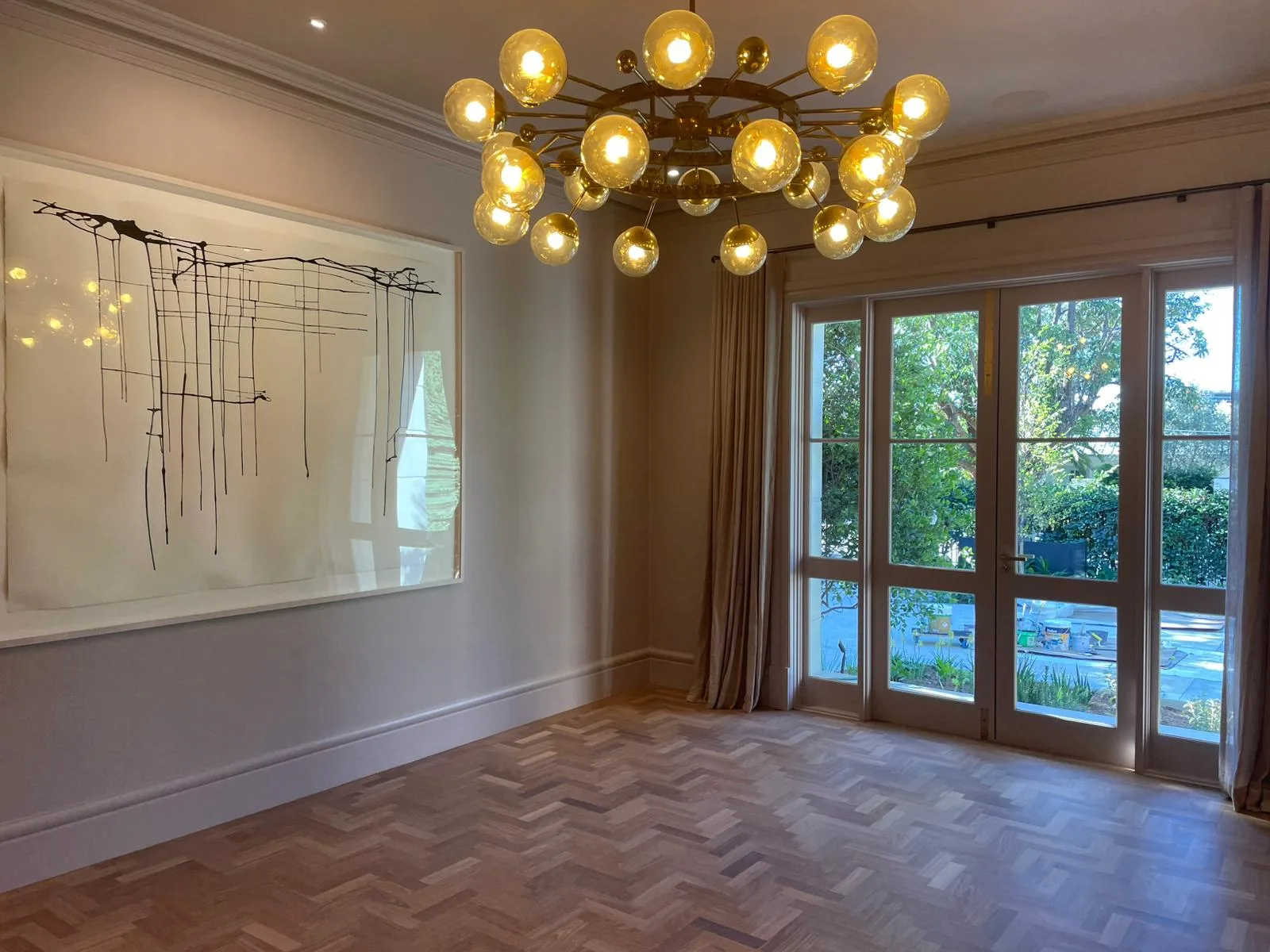 Interior repaint, dining room with parquetry floor and brass chandelier, Sydney