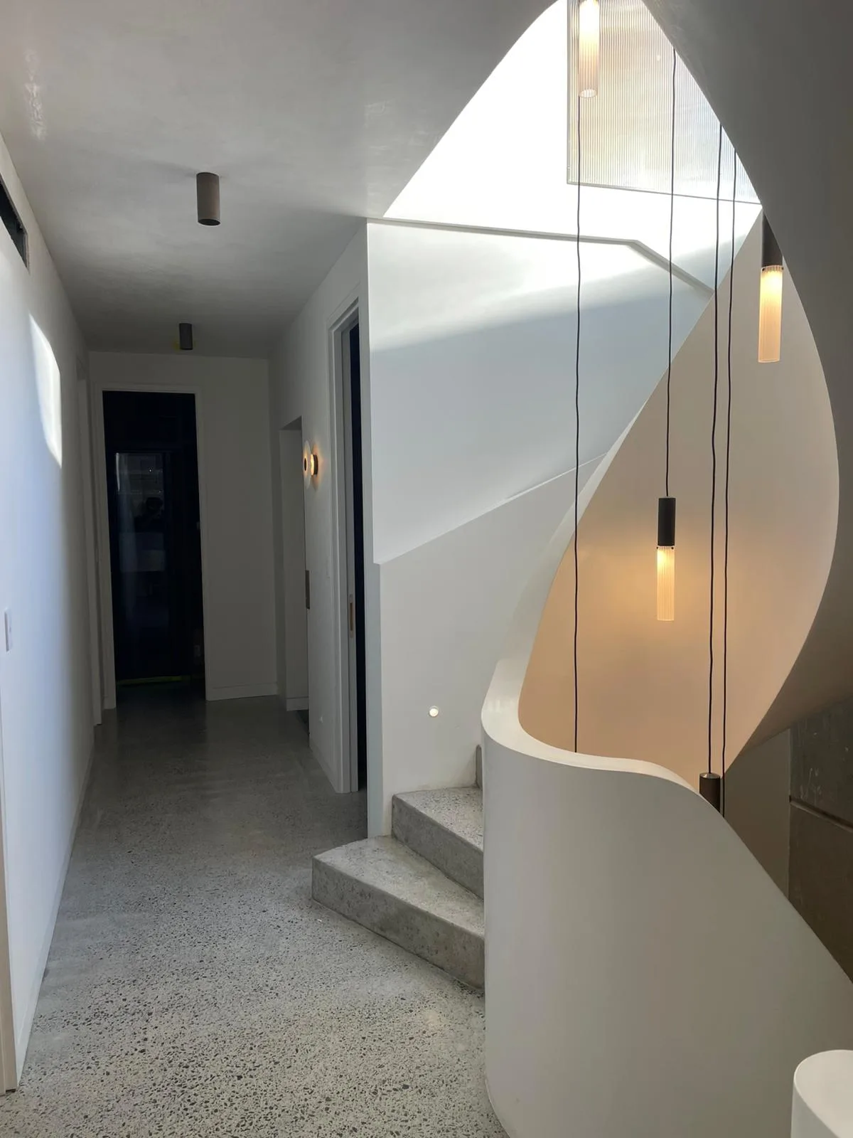 Interior repaint, curved stair wall and pendant lights, Sydney