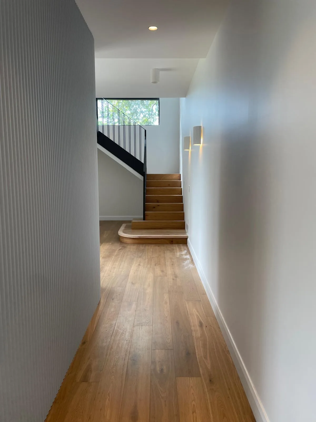 Interior repaint, curved hallway wall and stair beyond, Sydney