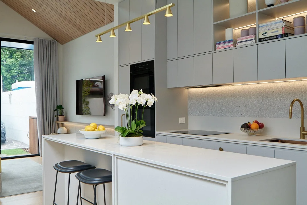 Interior repaint, white kitchen under a raked timber ceiling, Sydney