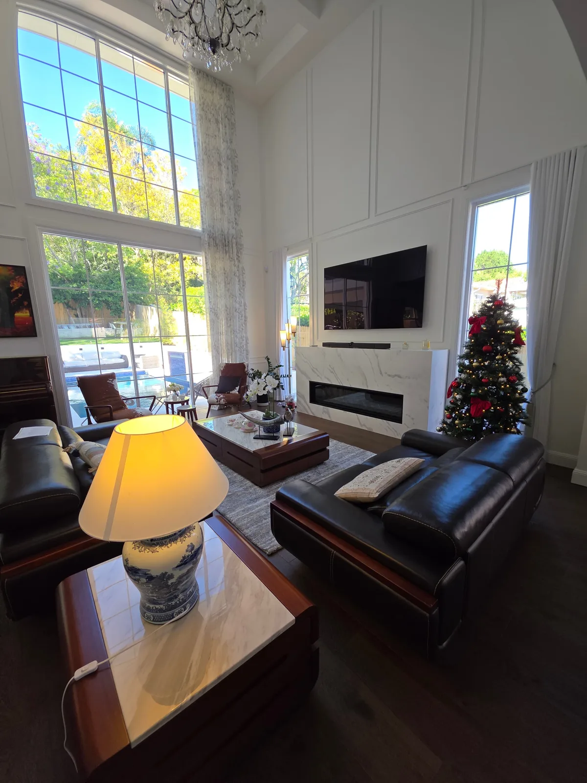 Interior repaint, living room with marble fireplace and full height windows to the pool, Sydney