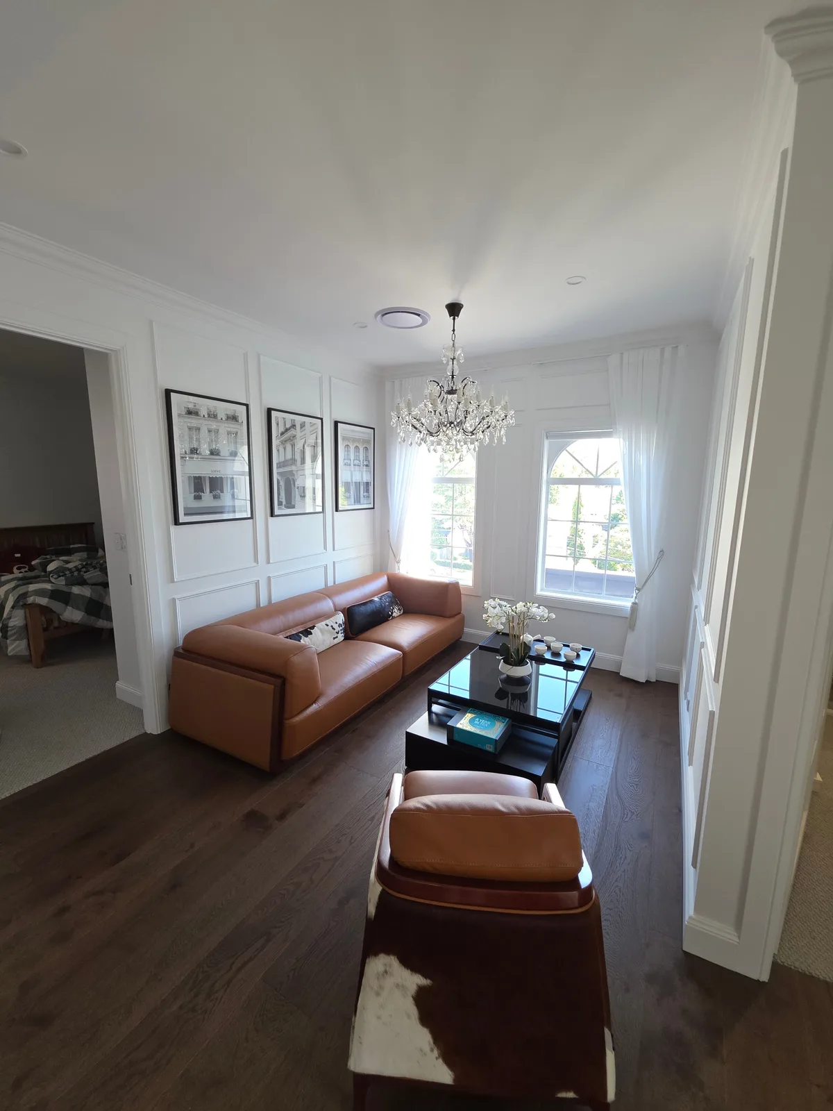 Interior repaint, panelled sitting room with crystal chandelier and arched windows, Sydney