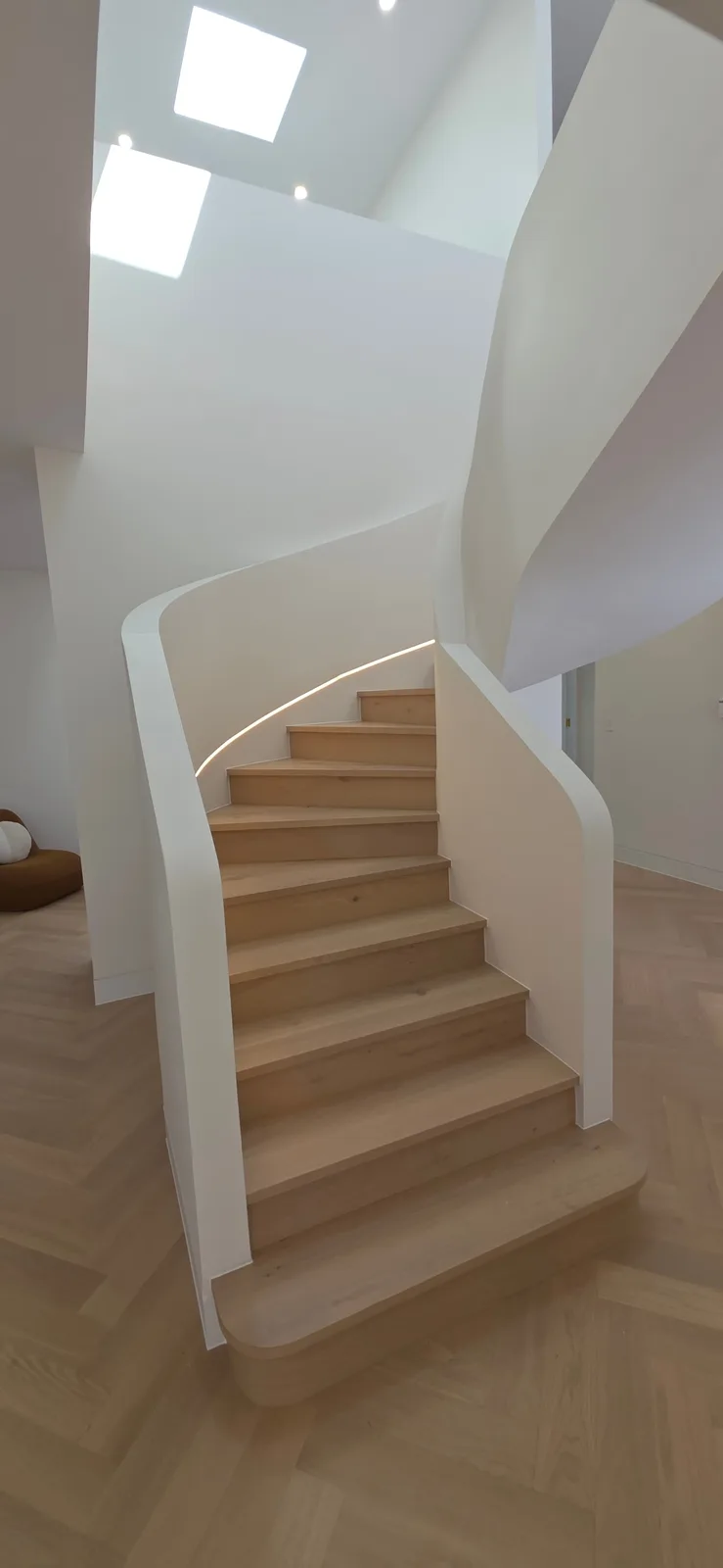 Interior repaint, curved white stair with oak treads under skylights, Sydney