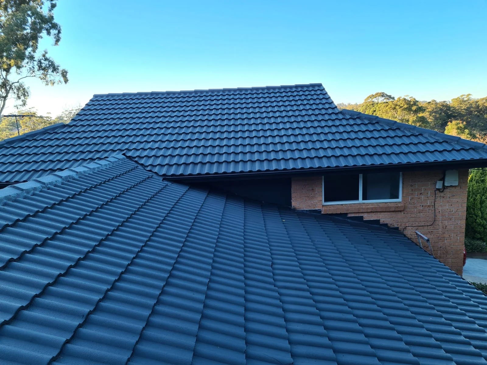Roof painting, tiled hip roof coated in charcoal, Sydney