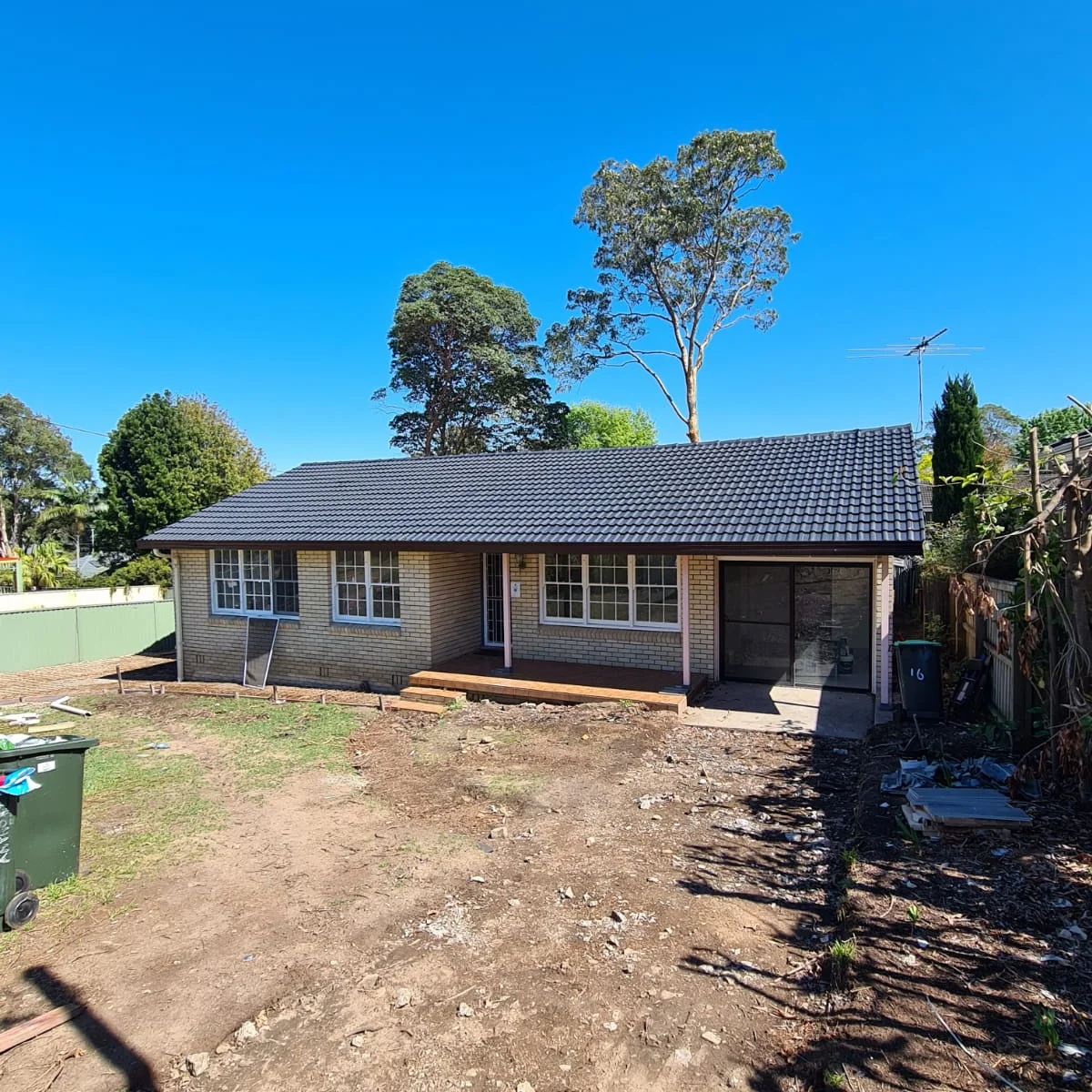 Roof painting, brick home with a freshly coated charcoal tile roof, Sydney